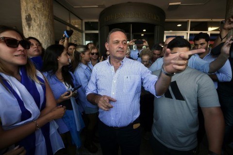 Uruguay's presidential candidate for the Republican Coalition, Alvaro Delgado (C) cast his vote in the capital Montevideo