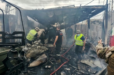 Rescuers douse the flames at the scene of an Israeli airstrike that hit a Lebanese army post in southern Lebanon