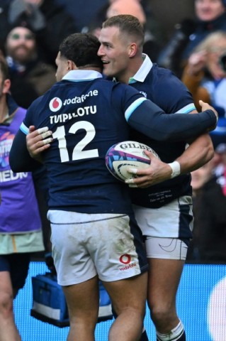 Try time: Scotland' wing Duhan van der Merwe (R) celebrates with skipper Sione Tuipulotu (L) after scoring against Australia at Murrayfield