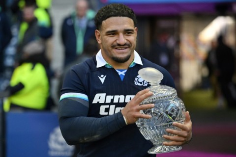 Eyes on the prize: Scotland captain Sione Tuipulotu collects the trophy after the 27-13 win over Australia at Murrayfield