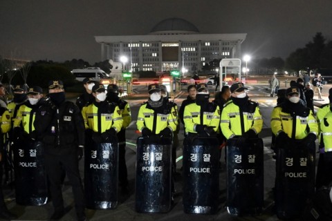 Police stand guard in front of the main gate of the National Assembly in Seoul after President Yoon Suk Yeol declared emergency martial law