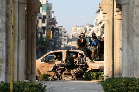 Rebel forces patrol the streets of Hama