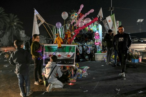 A street vendor sells toys and balloons near the Citadel of Aleppo, Syria's second city that was taken by the rebels early in the offensive