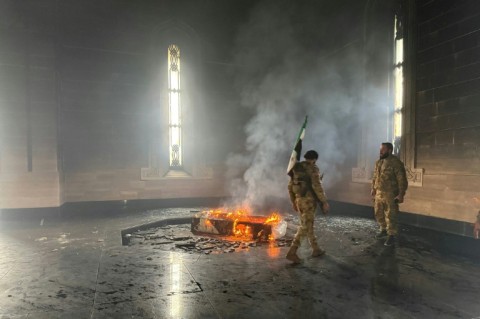 Rebel fighters set fire to the tomb of Assad's father and predecessor Hafez in their home village of Qardaha