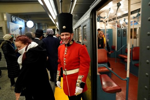 The return of 1930s subway cars in New York has led to travelers in period-appropriate costume standing alongside passengers in contemporary fashion, forming a delightfully anachronistic mix