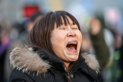 A protester calling for the ouster of South Korea President Yoon Suk Yeol reacts after the result of the second martial law impeachment vote outside the National Assembly in Seoul on December 14, 2024. South Korean lawmakers on December 14 voted to remove President Yoon Suk Yeol from office for his failed attempt to impose martial law last week.