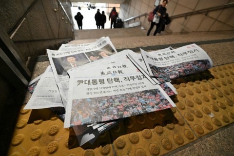 Extra edition newspapers are displayed at a subway station gate in downtown Seoul after the impeachment motion against South Korean President Yoon Suk Yeol was passed