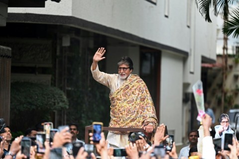 Indian paparazzi and fans take pictures and videos of Bollywood actor Amitabh Bachchan outside his residence in Mumbai