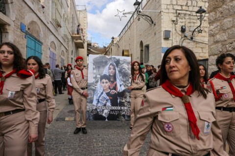 A small parade of Palestinian scouts included banners speaking out against the war in Gaza