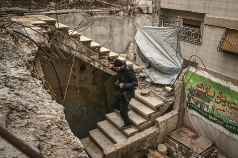 AFP photographer Sameer al-Doumy looks around his damaged home in Douma near Damascus 