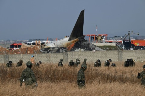 South Korean soldiers comb the crash site at Muan International Airport in South Jeolla Province