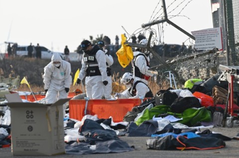 Firefighters and rescue personnel working after the Jeji Air crash