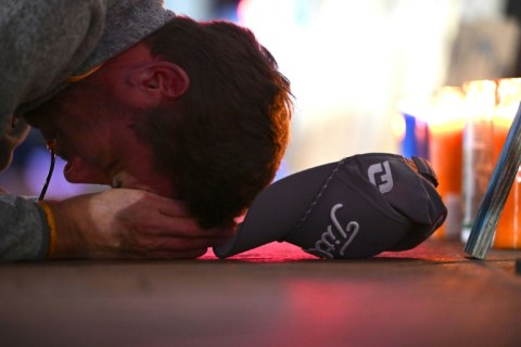 A man mourns at a memorial on New Orlean's Bourbon Street on January 2, 2025