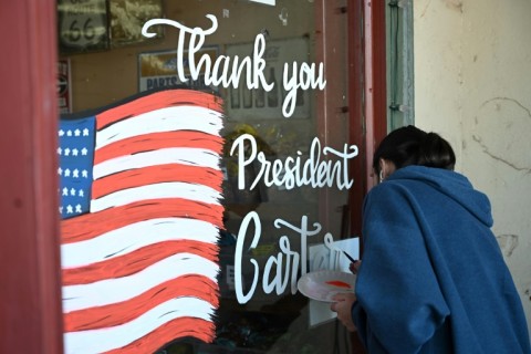 A mural in memory of Jimmy Carter is painted on a storefront in his hometown of Plains, Georgia