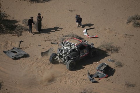 Sebastien Loeb starts rolling again after patching up his car following a crash on stage three of the Dakar Rally