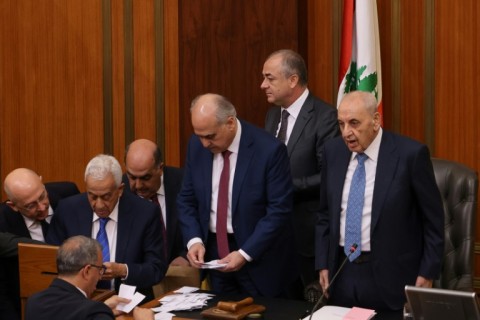 Lebanon's parliamentary speaker Nabih Berri (R) stands with lawmakers as they count votes in the session to elect a president