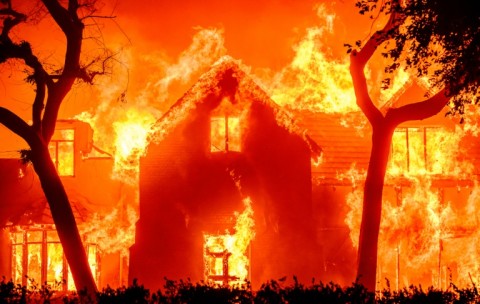 A home is engulfed in flames during in the Altadena area of Los Angeles County