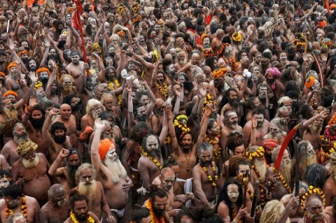 Naga Sadhus or Hindu holy men arrive to take a dip in Sangam, the confluence of Ganges, Yamuna and mythical Saraswati rivers