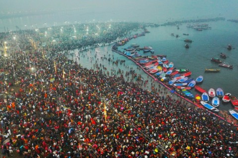 Hindu pilgrims taking a holy dip in the sacred waters of Sangam