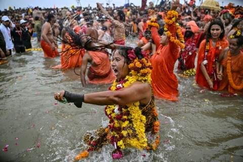 Sadhvis or Hindu holy women take part in a mass bathing ritual in Sangam