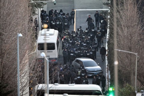 Police officers enter the compound of the presidential residence of impeached South Korea President Yoon Suk Yeol in Seoul