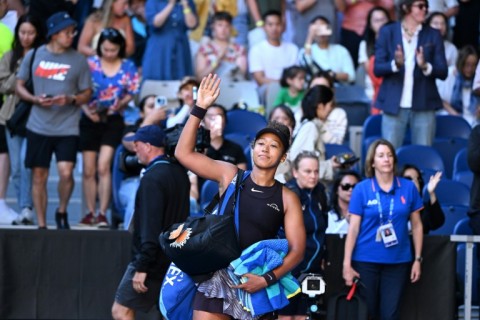 Japan's Naomi Osaka leaves the court after retiring due to injury