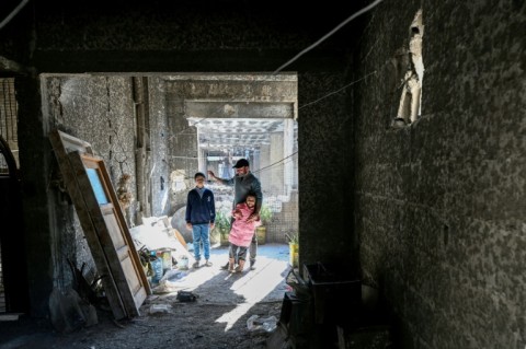 Ahmad Kafozi and his children are staying with relatives because their home is too badly damaged