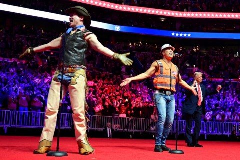 Donald Trump dances as the Village People perform at a MAGA victory rally at Capital One Arena in Washington