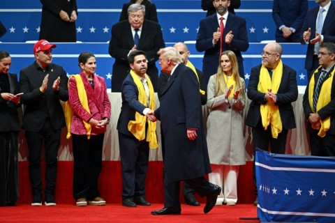 US President Donald Trump greets relatives of Israeli hostages taken by Hamas during the inaugural parade inside Capital One Arena in Washington