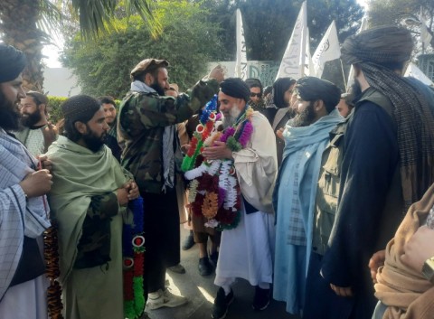 Taliban authorities welcomed Afghan fighter Khan Mohammed (C) who was imprisoned in the United States, as he arrived in Jalalabad in eastern Nangarhar province