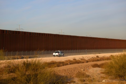 A US Customs and Border Protection vehicle patrols along the US-Mexico border in El Paso