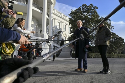 US President Donald Trump, with First Lady Melania Trump, speaks to the press before boarding Marine One on the South Lawn of the White House in Washington, DC, on January 24, 2025. Trump travels to Asheville, North Carolina, to visit the region devastated by Hurricane Helene. 