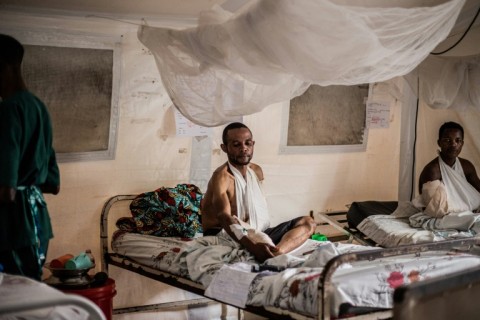 A Congolese soldier wounded during clashes with the M23 sits on a bed as he receives medical treatment at the ICRC hospital