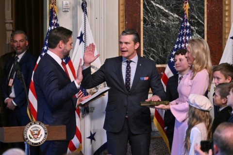 Pete Hegseth (C) -- surrounded by his wife and children -- is sworn in as the new US secretary of defense by Vice-President JD Vance (L)