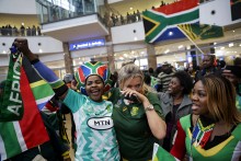 Supporters react ahead of the South African rugby team's arrival at the OR Tambo International airport in Ekurhuleni on October 31, 2023, after they won the France 2023 Rugby World Cup final match against New Zealand.