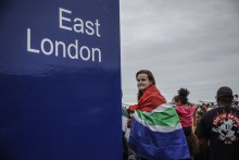 A supporter wears a South African flag during the Springboks Champions trophy tour in East London, South Africa, on November 5, 2023, after South Africa won the France 2023 Rugby World Cup final match against New Zealand.