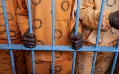 File: Inmates stand behind bars in The Maximum Security Section, of The Leeuwkop Correctional Facility, Bryanston.