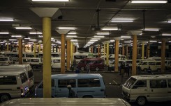 File: Commuters arrive at the Noord taxi rank in Johannesburg, on June 1, 2020. MARCO LONGARI / AFP