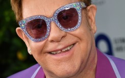 File: English singer-songwriter Elton John poses on the red carpet. AFP/Yann Coatsaliou 