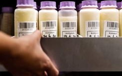 FILE: A member of staff of breast milk bank of the VUmc carries a boxe with bottles containing breast milk in Amsterdam, on August 19, 2020