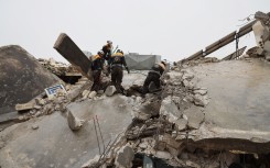 Members of the Syrian civil defence, known as the White Helmets look for casualties under the rubble following an earthquake in the town of Sarmada in the countryside of the northwestern Syrian Idlib province, early on February 6, 2023. Mohammed AL-RIFAI / AFP