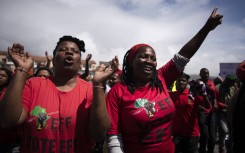 Supporters of the Economic Freedom Fighters (EFF) gesture as they march through the centre in Cape Town on March 20, 2023.