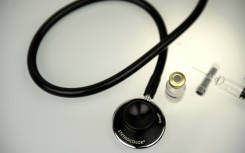 File: A picture taken on March 14, 2016 shows a solution for the treatment of severe hypoglycemia that may occur in diabetes and a stethoscope displayed on a desktop for an illustration in Paris.