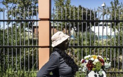 File: A woman pauses at the monument commemorating the victims of the 1960 Sharpeville massacre, in Sharpville. MARCO LONGARI / AFP