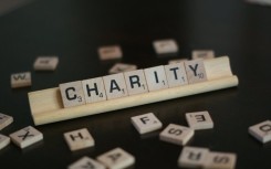 File image of the word 'charity' spelled in Scrabble tiles.