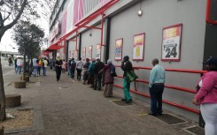 Sassa grant recipients keep a safe distance from each other in Athlone.