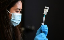 A Covid-19 vaccine is prepared for administration in the US, where a new study has helped provide some answers about the brain fog associated with the virus