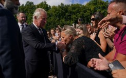 King Charles shook hands, accepted flowers and waved as people held up their phones to take selfies