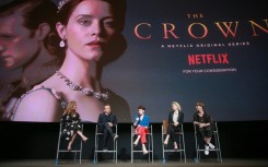 Cast members of the first season of Netflix's The Crown, including Claire Foy, who portrayed a young Queen Elizabeth II, are seen in 2018. Netflix says it has suspended filming on the show's latest season out of resepect for the late monarch 