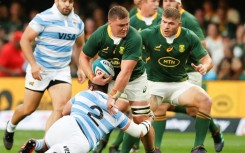 South Africa No. 8 Jasper Wiese (C) is tackled by Argentina hooker Julian Montoya